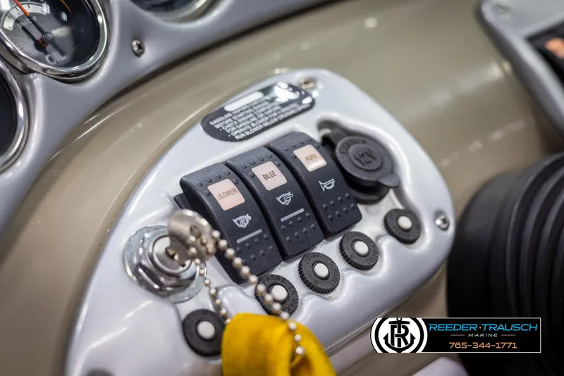Slide: The Image of Dashboard controls of a 2008 Crownline 240 EX boat, featuring switches and gauges. - 29