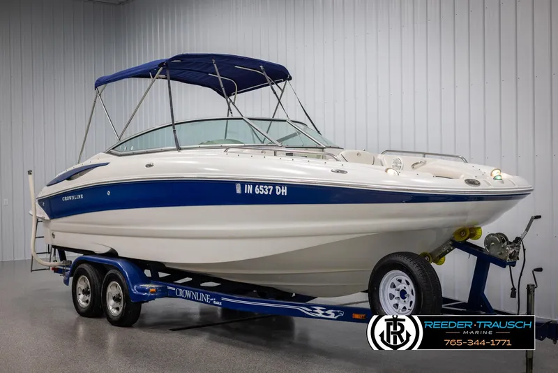 Slide: The Image of 2008 Crownline 240 EX boat on trailer in indoor showroom. - 3