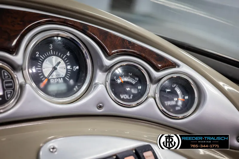 Slide: The Image of Dashboard of 2008 Crownline 240 EX boat with RPM, volt, and trim gauges. - 32