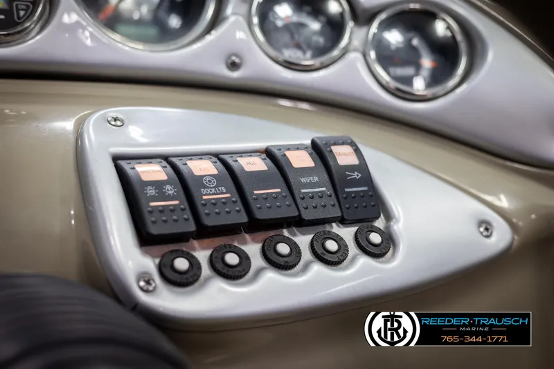Slide: The Image of Dashboard controls of 2008 Crownline 240 EX boat with switches and gauges. - 34
