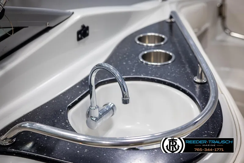 Slide: The Image of 2008 Crownline 240 EX boat sink with chrome faucet and cup holders. - 36