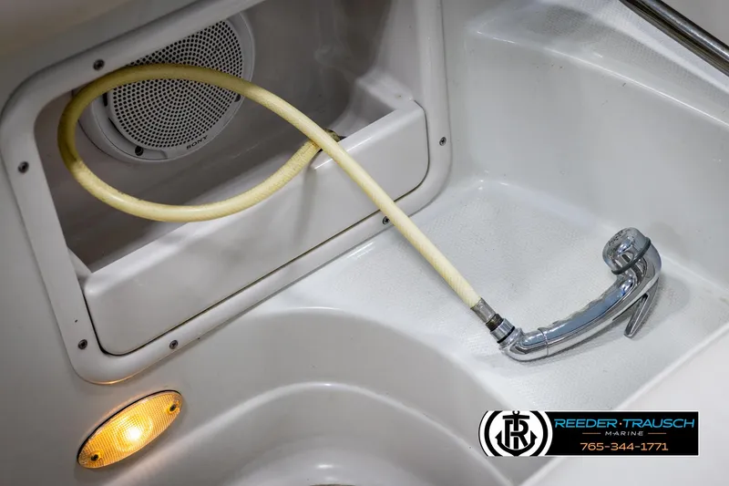 Slide: The Image of 2008 Crownline 240 EX boat interior with hose and speaker detail. - 43