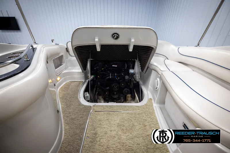 Slide: The Image of 2008 Crownline 240 EX boat engine compartment with open hatch, showcasing interior details. - 46
