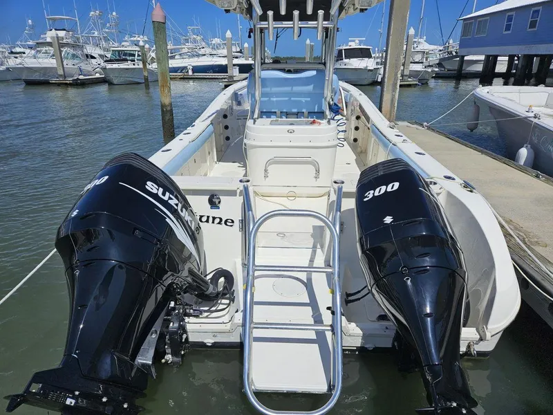 Slide: The Image of 2010 World Cat 290 CC boat with twin Suzuki 300 engines docked at marina. - 3