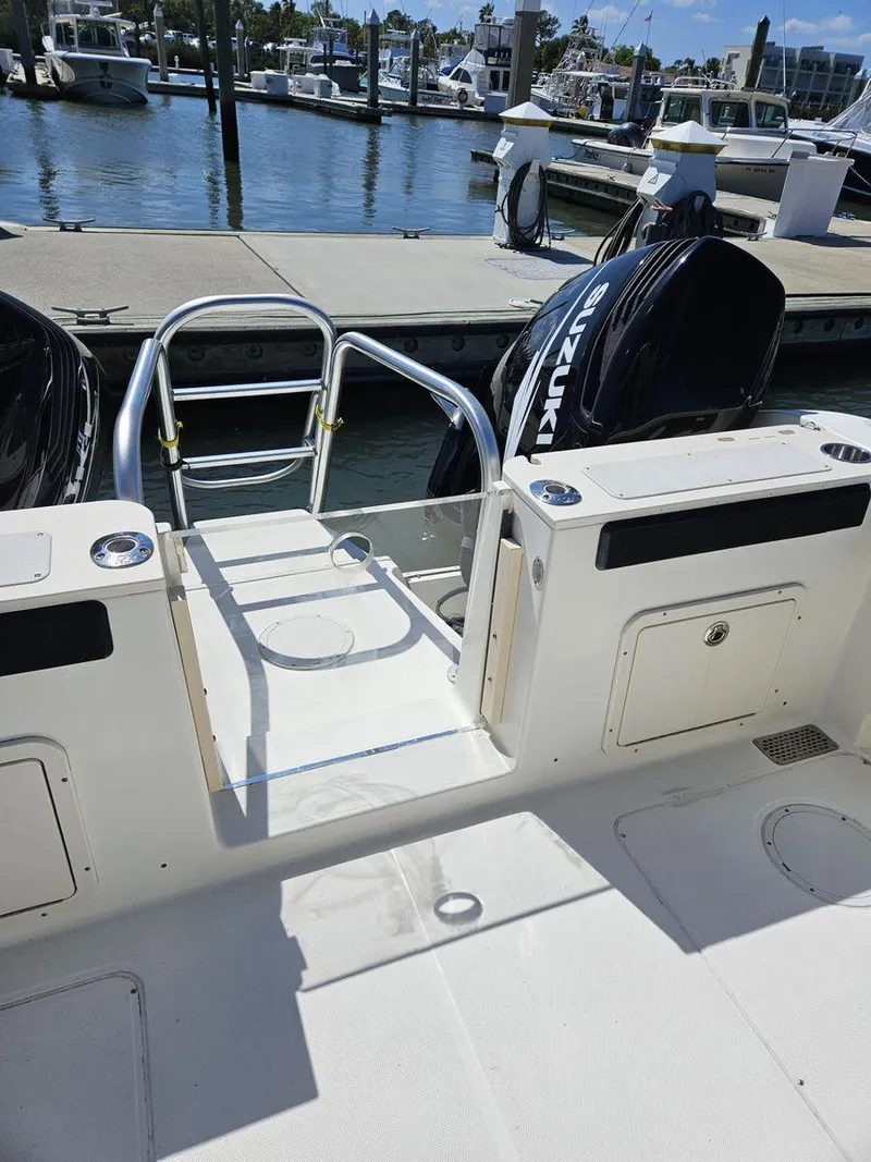 Slide: The Image of 2010 World Cat 290 CC boat with Suzuki engines at marina dock. - 6