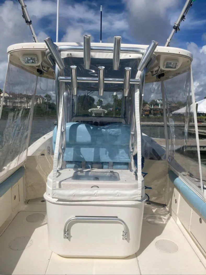 Slide: The Image of 2010 World Cat 290 CC boat with clear canopy and blue seating. - 7