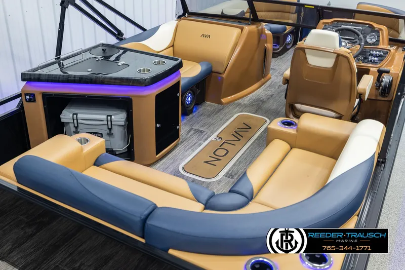 Slide: The Image of Luxurious 2025 Avalon LSZ ELW boat interior with tan and blue seating, modern dashboard, and entertainment area. - 12