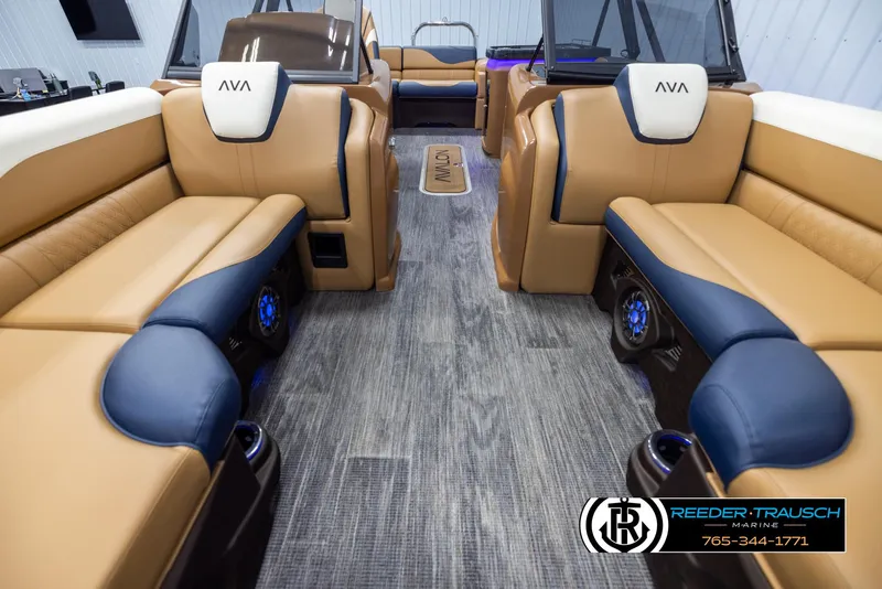Slide: The Image of Luxurious interior of 2025 Avalon LSZ ELW pontoon boat with tan and blue seating. - 13