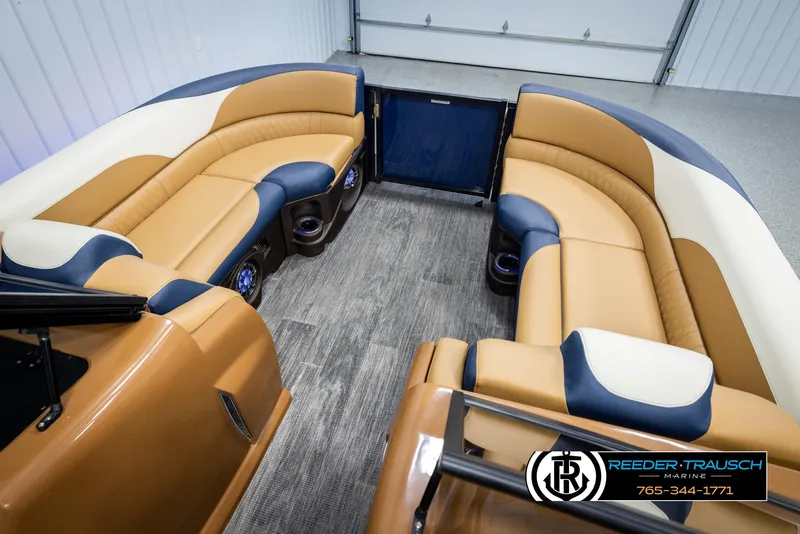 Slide: The Image of Luxurious 2025 Avalon LSZ ELW boat interior with tan and navy seating. - 19