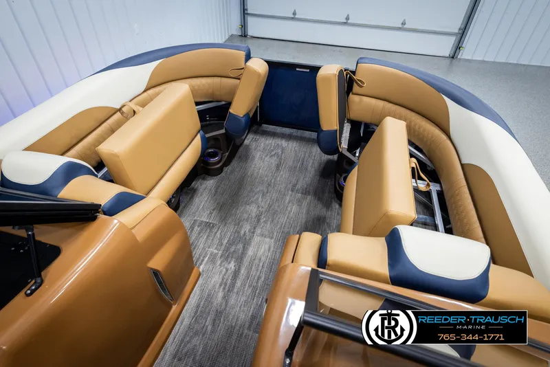 Slide: The Image of Luxurious 2025 Avalon LSZ ELW boat interior with tan and navy seating. - 20