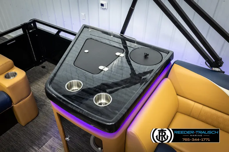 Slide: The Image of 2025 Avalon LSZ ELW boat interior with sleek black console and cup holders. - 25