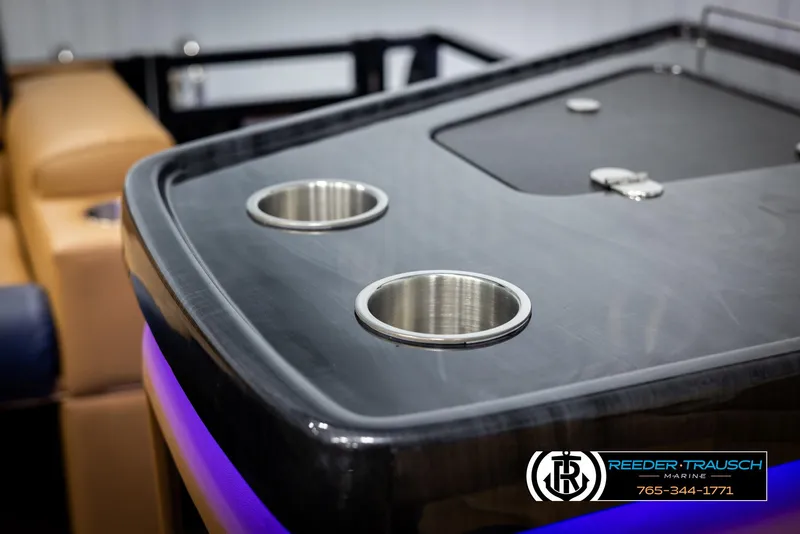 Slide: The Image of 2025 Avalon LSZ ELW boat interior with cup holders and sleek design. - 43