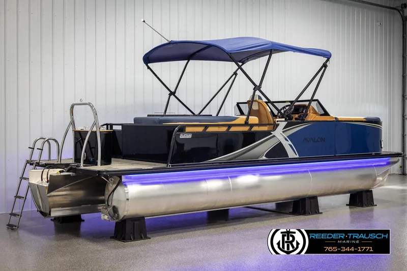 Slide: The Image of 2025 Avalon LSZ ELW pontoon boat with blue canopy and LED lights in showroom. - 6