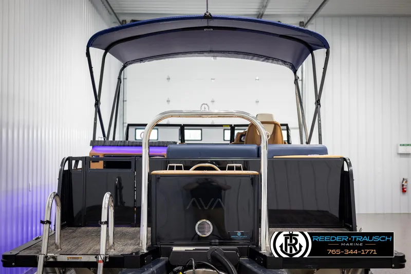 Slide: The Image of 2025 Avalon LSZ ELW pontoon boat with canopy in a showroom. - 7