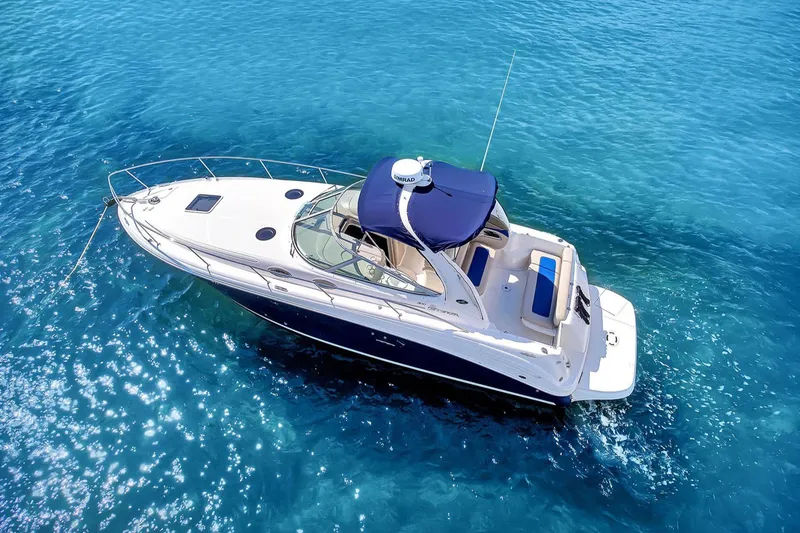 Slide: The Image of 2006 Sea Ray 300 Sundancer yacht on clear blue water. - 2