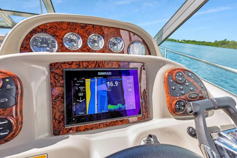 Slide: The Image of Dashboard of 2006 Sea Ray 300 Sundancer with navigation display and controls. - 5