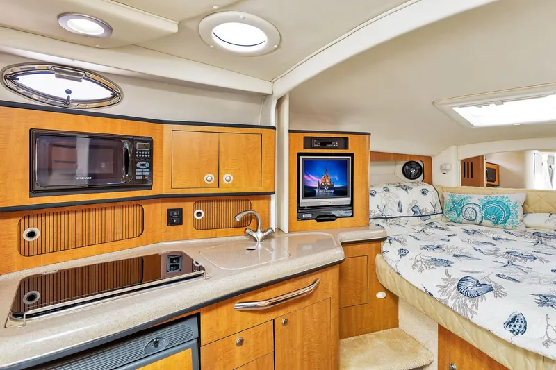 Slide: The Image of Interior of 2006 Sea Ray 300 Sundancer with kitchenette and cozy sleeping area. - 8