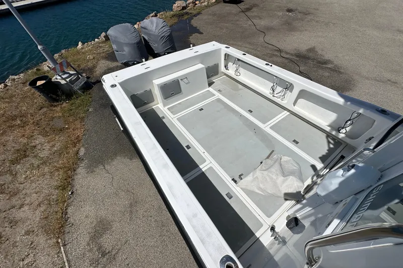 Slide: The Image of 2012 Davis Rock Harbor 25 boat interior, docked near water, showing spacious deck layout. - 16