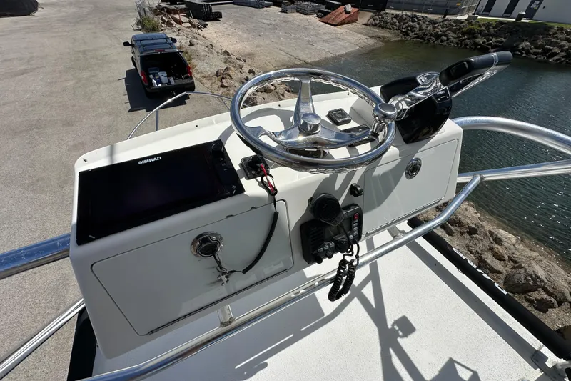 Slide: The Image of Helm of 2012 Davis Rock Harbor 25 boat with steering wheel and navigation equipment. - 28