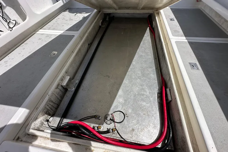 Slide: The Image of Open storage compartment in a 2012 Davis Rock Harbor 25 boat, showing cables and wiring. - 32