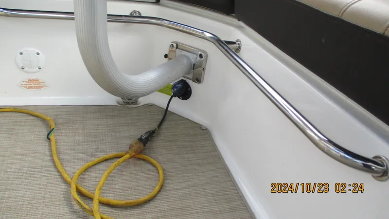 Slide: The Image of Sea Ray SLX 250 boat interior with hose and power cable, 2020 model. - 25