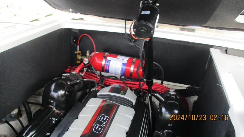 Slide: The Image of Engine compartment of 2020 Sea Ray SLX 250 with fire extinguisher and 6.2-liter engine. - 26