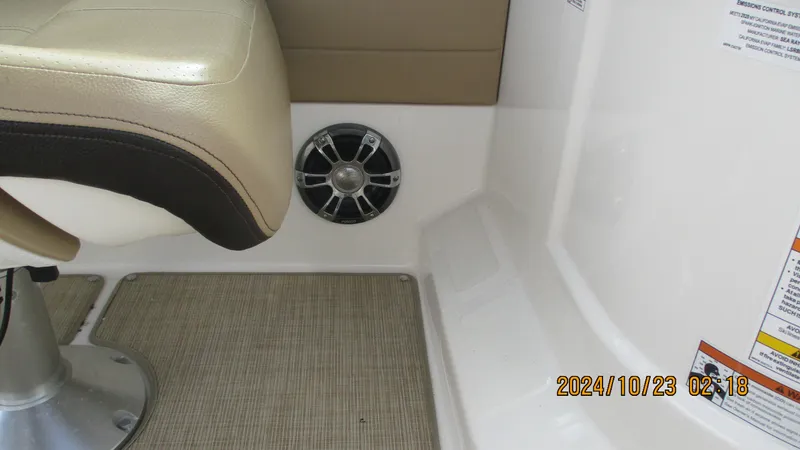 Slide: The Image of 2020 Sea Ray SLX 250 boat interior with beige seating and speaker. - 20