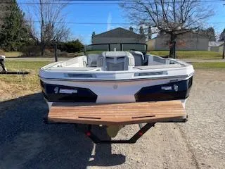 Slide: The Image of 2024 MasterCraft ProStar boat on trailer, parked outdoors. - 2