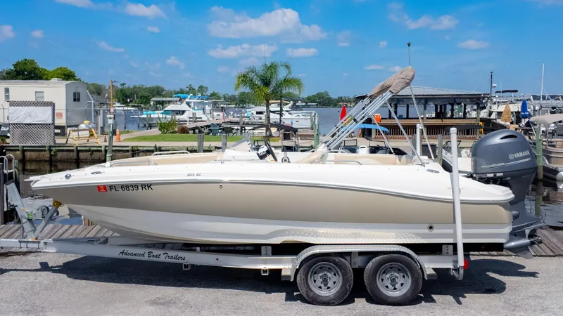 Slide: The Image of 2017 NauticStar 203 SC boat on trailer at marina, sunny day. - 1