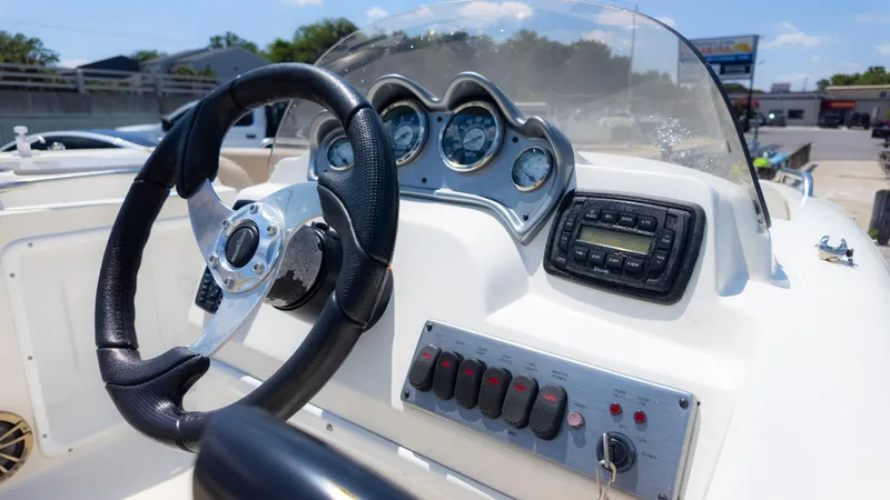 Slide: The Image of 2017 NauticStar 203 SC boat dashboard with steering wheel and control panel. - 14