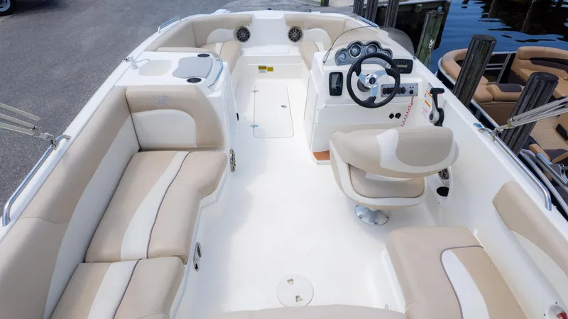 Slide: The Image of 2017 NauticStar 203 SC boat interior with beige seating and steering console. - 19