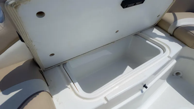 Slide: The Image of Open storage compartment on 2017 NauticStar 203 SC boat, featuring beige seating. - 23