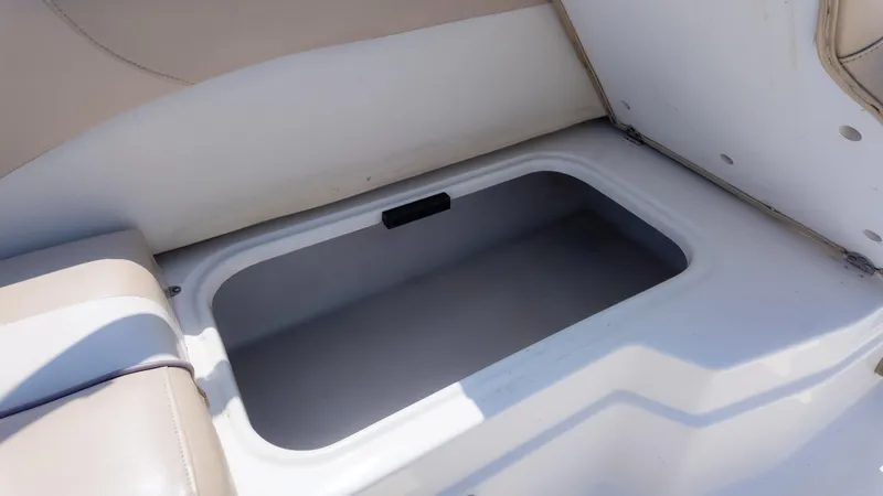 Slide: The Image of 2017 NauticStar 203 SC boat storage compartment with beige seating. - 25