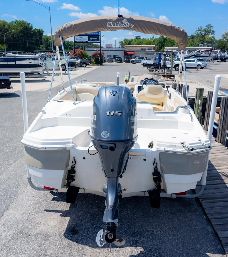 Slide: The Image of 2017 NauticStar 203 SC boat with Yamaha 115 outboard motor at a marina. - 4