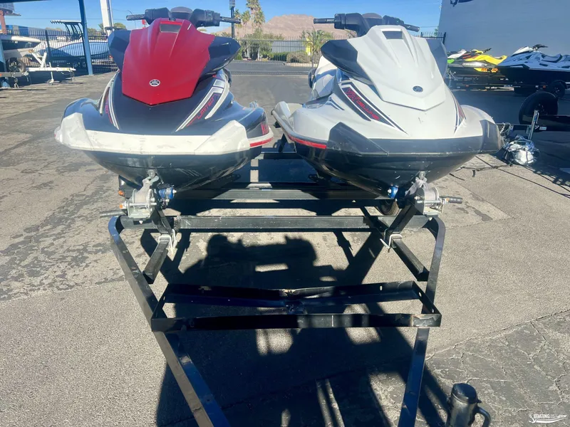 Slide: The Image of 2018 Yamaha WaveRunner VX Cruiser/Limited jet skis on a trailer in a parking lot. - 2