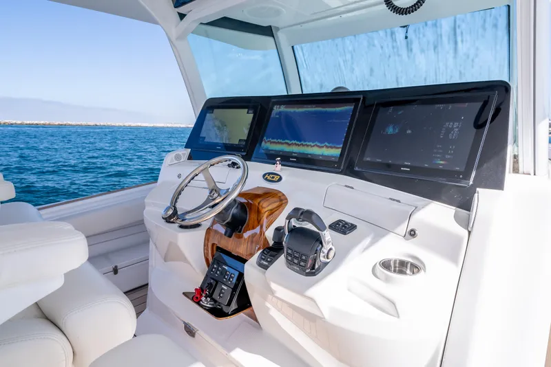 Slide: The Image of HCB 53 Sueños 2020 boat helm with advanced navigation displays on open water. - 16