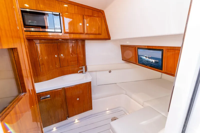 Slide: The Image of Luxurious interior of 2020 HCB 53 Sueños yacht with wood cabinetry and seating. - 17
