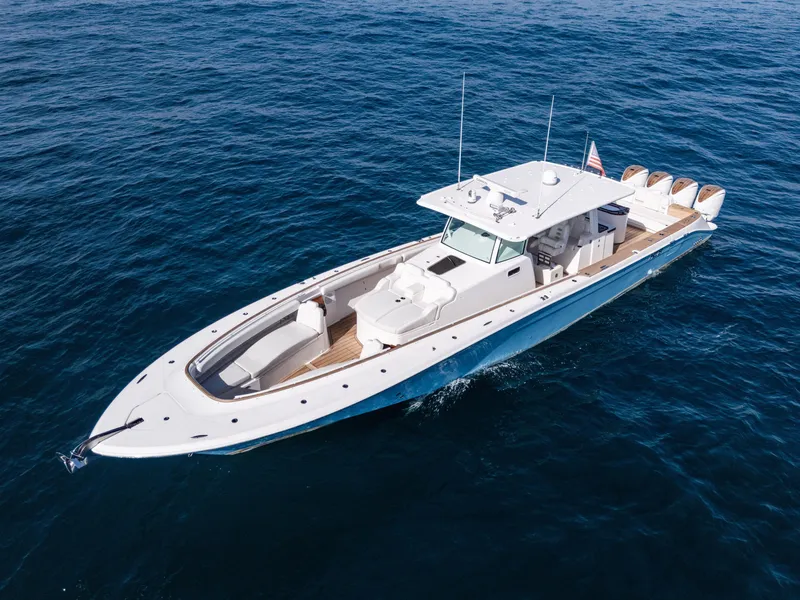 Slide: The Image of 2020 HCB 53 Sueños luxury boat cruising on open water. - 2