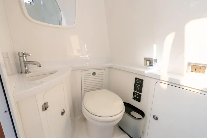 Slide: The Image of 2020 HCB 53 Sueños boat bathroom with modern fixtures and white interior. - 21