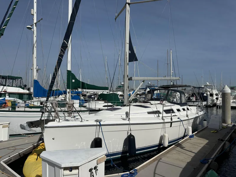 Slide: The Image of 2008 Hunter 38 sailboat docked at marina under clear sky. - 0
