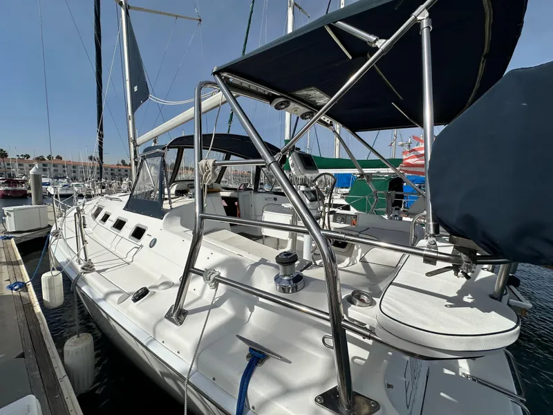 Slide: The Image of 2008 Hunter 38 sailboat docked at marina, featuring sleek design and spacious deck. - 11