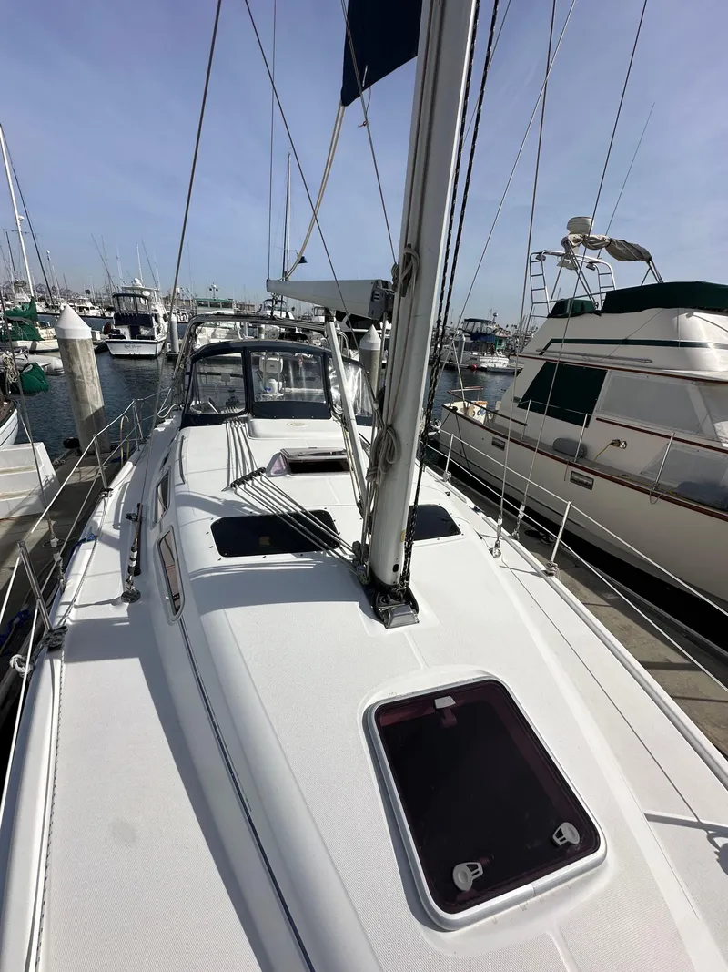 Slide: The Image of 2008 Hunter 38 sailboat docked at marina, view of deck and mast. - 16