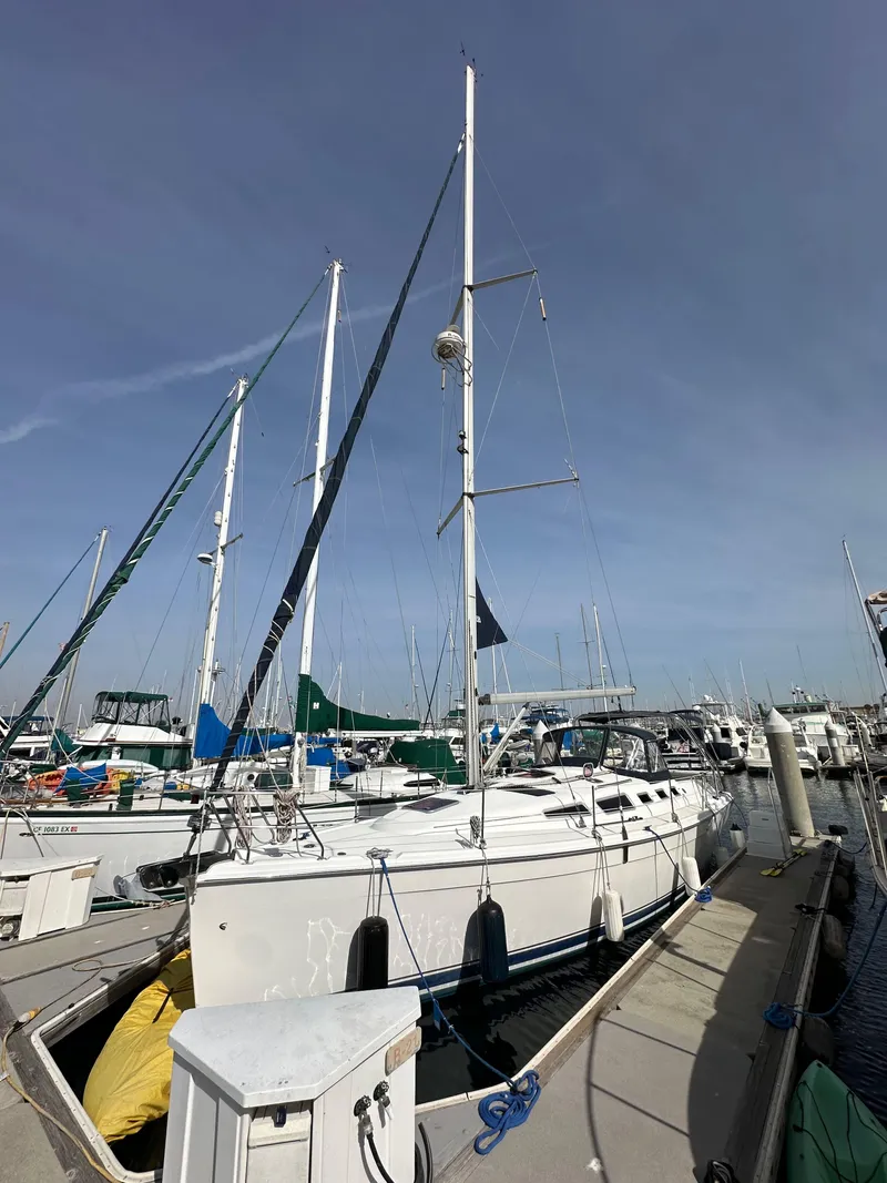 Slide: The Image of 2008 Hunter 38 sailboat docked at marina under clear sky. - 2