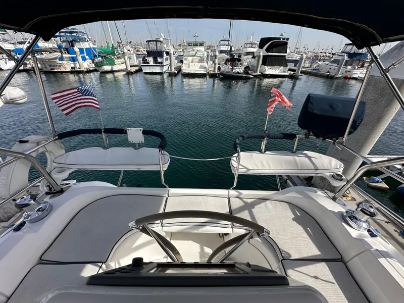 Slide: The Image of 2008 Hunter 38 sailboat docked at marina with American flags. - 20