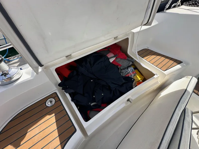 Slide: The Image of Open storage compartment on 2008 Hunter 38 sailboat with clothes inside. - 30