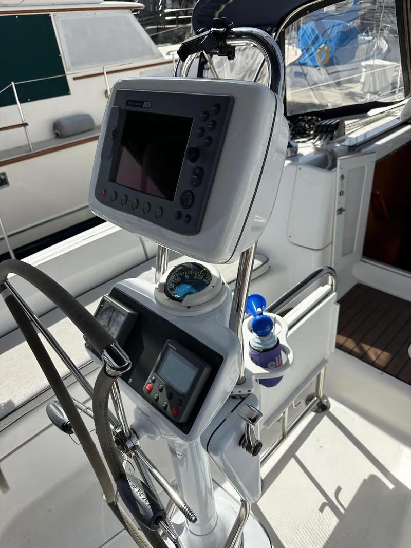 Slide: The Image of 2008 Hunter 38 yacht cockpit with navigation equipment and steering wheel. - 33