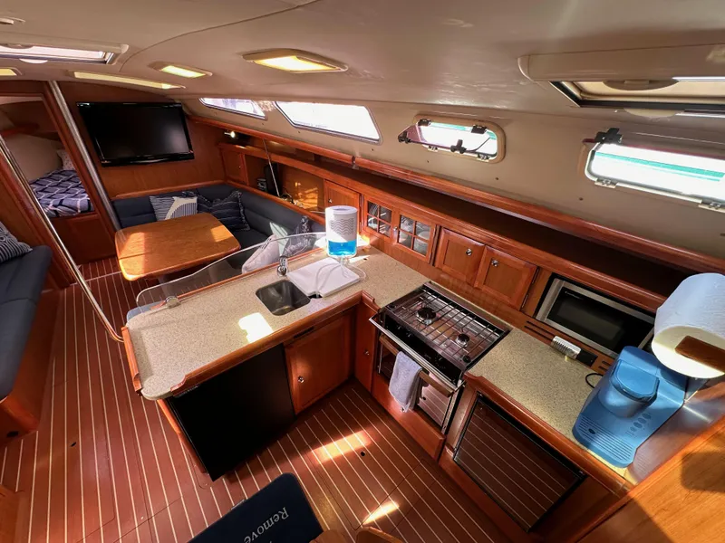Slide: The Image of Interior of 2008 Hunter 38 sailboat with modern kitchen and seating area. - 40