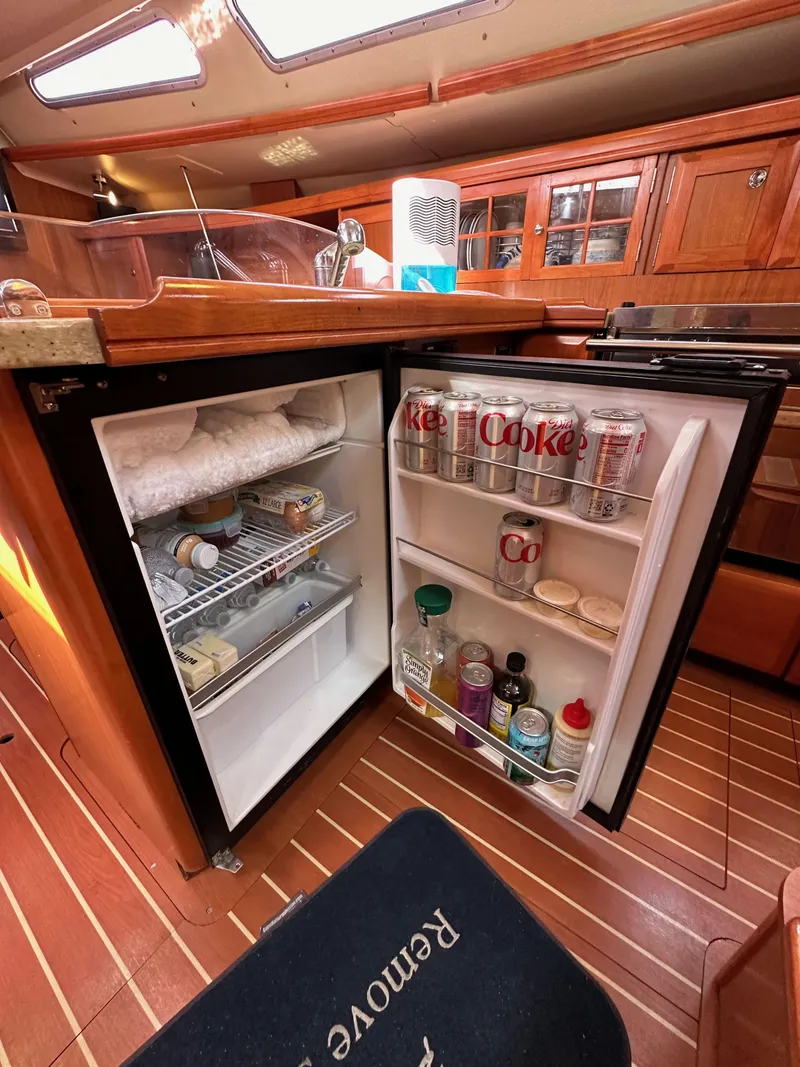 Slide: The Image of Open fridge in 2008 Hunter 38 yacht interior, stocked with drinks and condiments. - 44