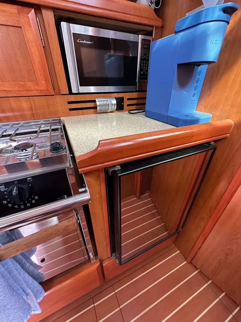 Slide: The Image of 2008 Hunter 38 yacht kitchen with microwave, stove, fridge, and coffee maker. - 45