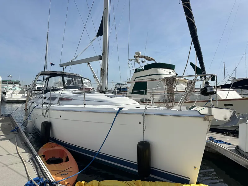 Slide: The Image of 2008 Hunter 38 sailboat docked at marina, sunny day, nearby kayaks. - 5